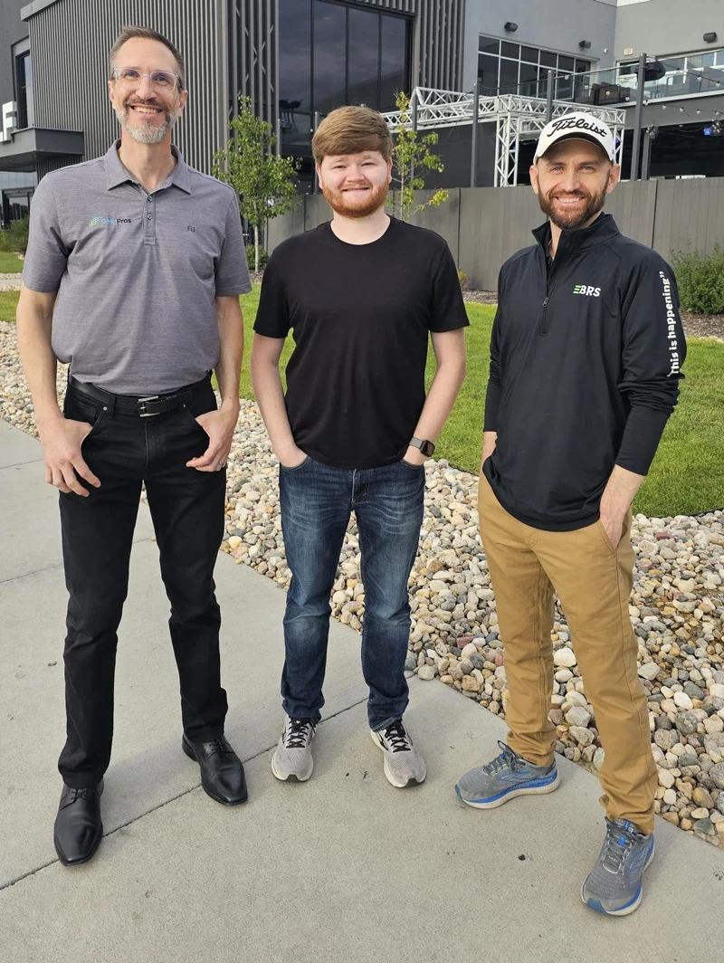 Eric Clark, Kyle Swartzendruber, and Justin Tome, members of GMP Pros Team, standing outside of a building