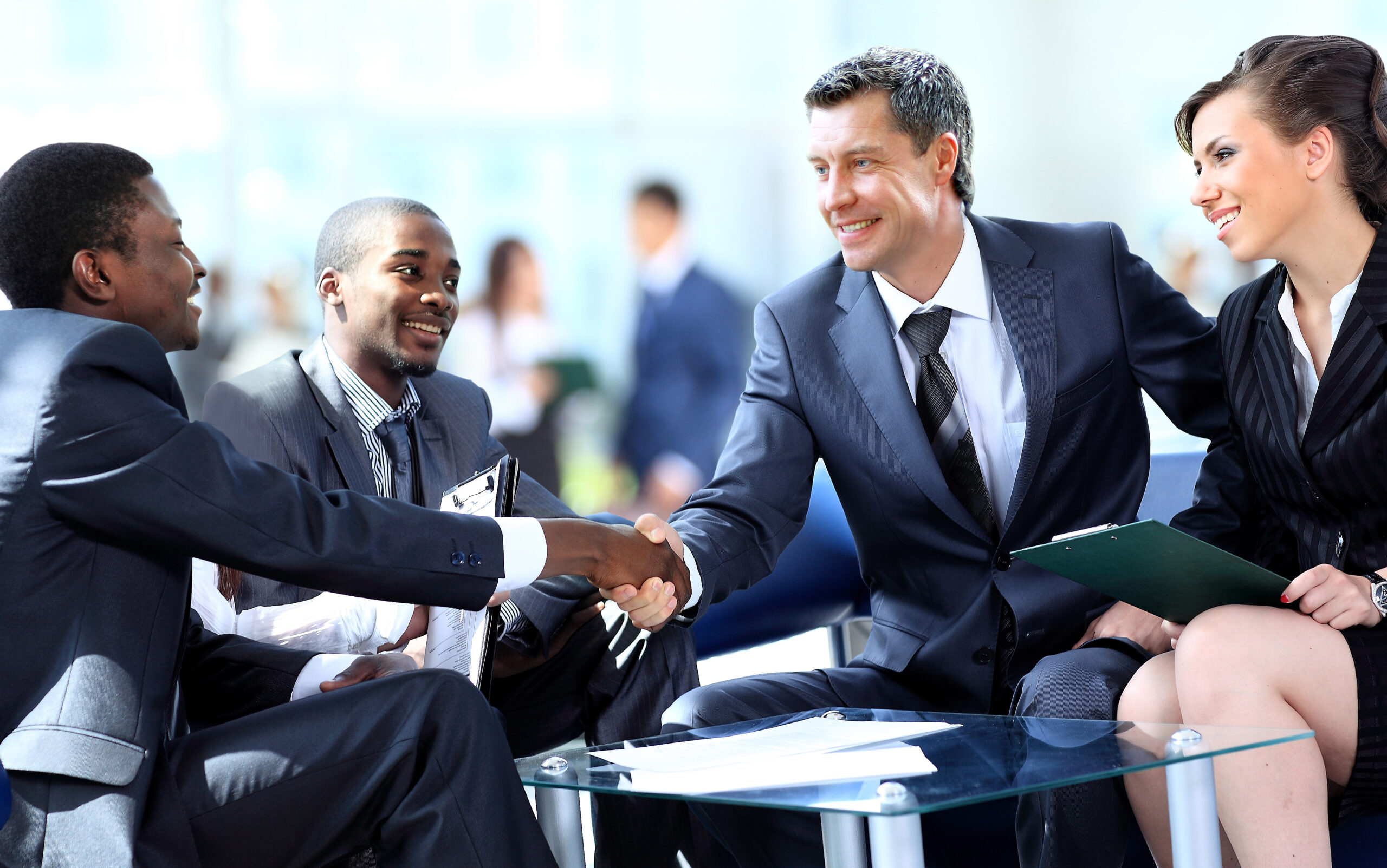 A group of business professionals shaking hands and collaborating in a professional setting