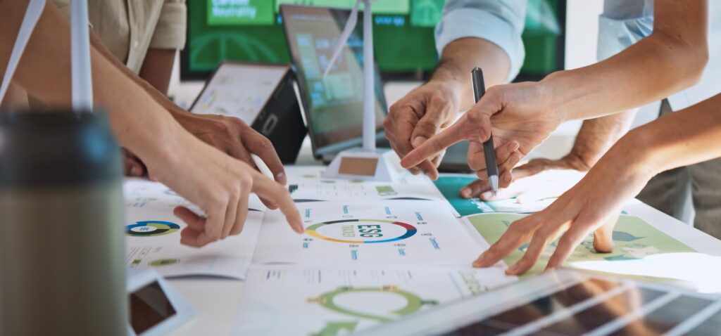 Close-up of team members analyzing MES system performance metrics and data quality charts.