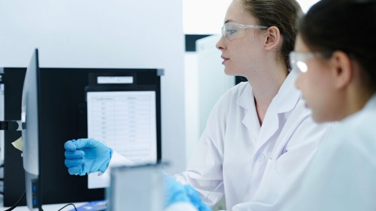 Life Science Project Management Consulting 20 Batch record management best practices for pharma: scientists reviewing electronic batch records and quality control data in pharmaceutical laboratory